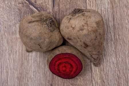 The red beets on a brown wooden backgroundの写真素材