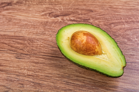 Cut avocado on a wooden backgroundの写真素材
