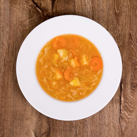 Vegetarian vegetable soup on a wooden tableの写真素材
