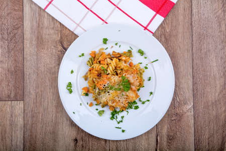 Vegetarian food on a white plate with wooden backgroundの写真素材