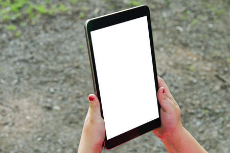 Black tablet in women hands and blurred background