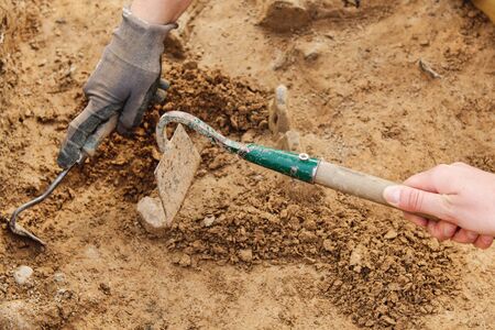 Archeological tools, Archeologist working on site, close-up, hand and tool.の写真素材