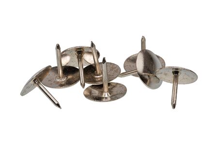 Group of metal thumb tacks isolated on a white background