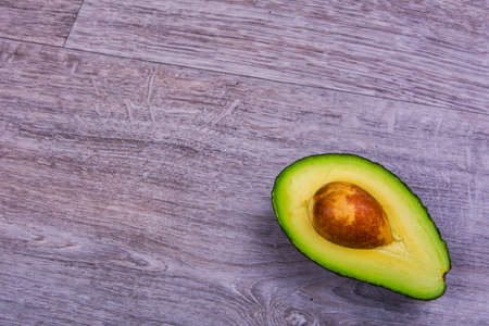 Cut avocado on a wooden tableの写真素材