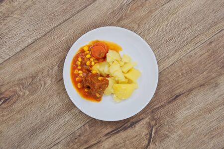 Mexican goulash with potatoes on a wooden tableの写真素材