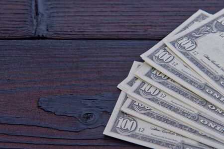 Dollar banknotes on a wooden tableの写真素材