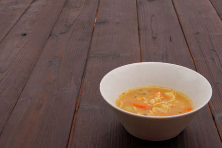 Bean soup with noodles on a wooden backgroundの写真素材