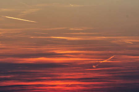 Fiery orange sunset sky with clouds. Beautiful sky.