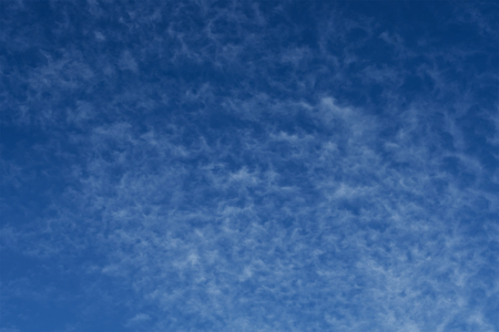 Clear blue sky with plain white cloud with space for text background. The vast blue sky and clouds