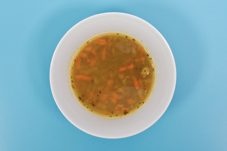 Lentil soup with carrots on a blue backgroundの写真素材