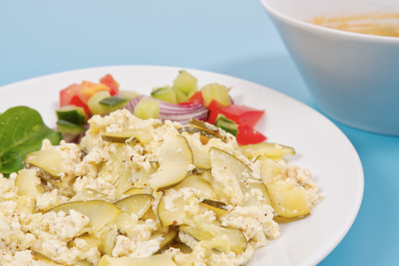 Baked zucchini vegetable salad on a white backgroundの写真素材