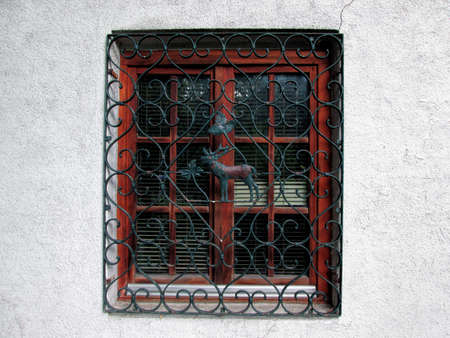 Old Window With Metal Grill On Facade. Metal Grill Grating Protection With Deer And Leaves In The...