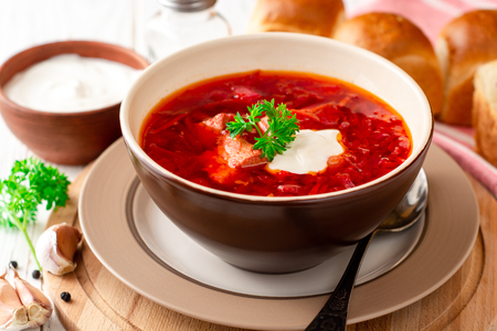 Borsch - traditional Ukrainian and Russian beetroot soup on white wooden background. Selective focus.の写真素材