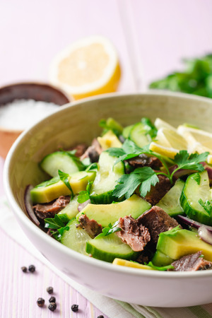 Fresh salad with vegetables and tuna in bowl on woodenの写真素材