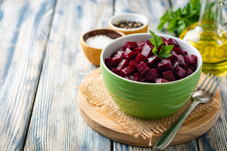 Beetroot salad with parsley in bowl on rustic wooden table. Selective focus.の写真素材