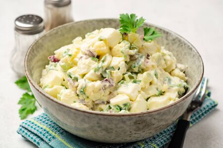 Egg salad with red onion and greens in bowl on concrete background. Selective focus.の写真素材