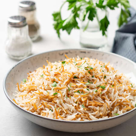 Rice with vermicelli in plate on concrete background. Traditional Arabic dish. selective focus.の写真素材