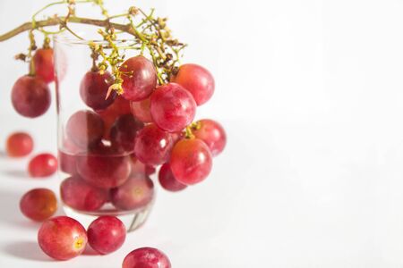 Red grape on glass, fruit for Healthy on white backgroundの写真素材