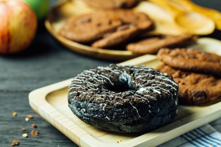 delicious chocolate donuts with cookies and appleの写真素材