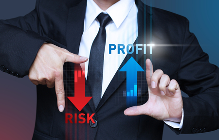 business man show increase profit and decrease risk of investment, management conceptの写真素材