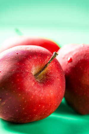 Red fresh apple group on green background, fruit for healthyの写真素材