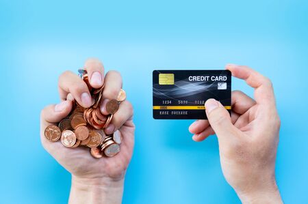 Hand hold credit card and coin or cash background