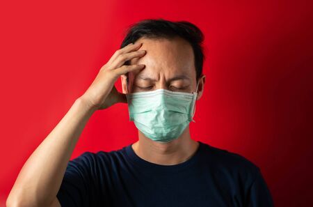 Sick man with mask touch head, virus Infect conceptの写真素材