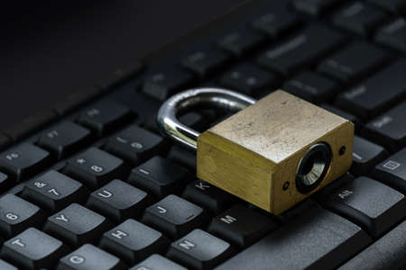 Master key on black keyboard, computer security privacy concept