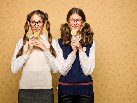 Young female nerds with lollypop