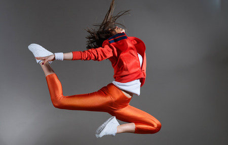 Modern hip-hop style teenage girl jumping