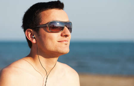 Portrait of young man at the beachの写真素材