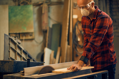 Carpenter at work in his workshopの写真素材