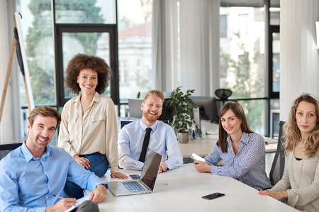 Small group of business people posing in office. Start up business concept. Multi ethnic group.の写真素材