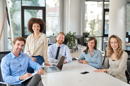 Small group of business people posing in office. Start up business concept. Multi ethnic group.