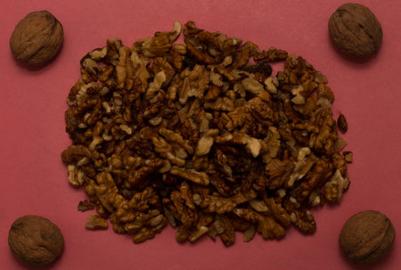 Walnuts on a pink background.