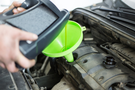 Car repair works. Oil changingの写真素材