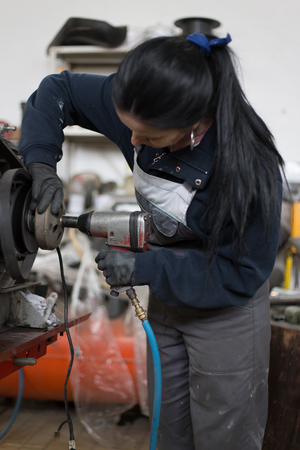 Girl worker in motorcycle repair shopの写真素材