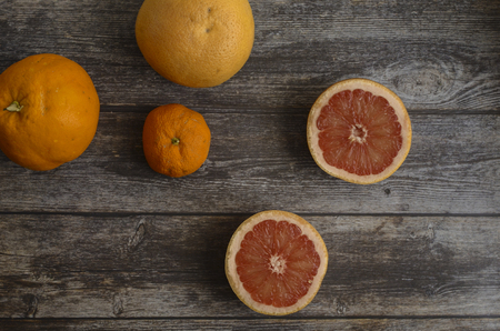 Red grapefruit on wooden backgroundの写真素材