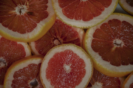 Grapefruit slices background. Top view, summer vibes color