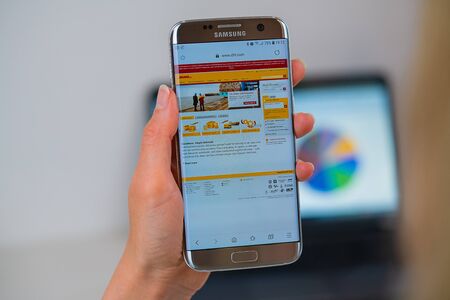 Barcelona / Spain 05 25 2019: DHL web site on mobile phone screen. Mobile version of DHL company web page on smartphone. Official web page of DHL.のeditorial素材