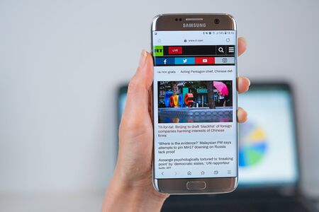 Barcelona / Spain 05 25 2019: RT web site on mobile phone screen. Mobile version of Russia Today company web page on smartphone. Official web page of Russia Today.のeditorial素材