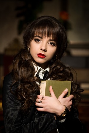 Beautiful, attractive, nice, pretty, delightful, innocent, serious, clever, smart, vintage, well-educated, well-mannered girl, business girl, woman, student, school girl, teacher, lady, model curly hair, red lips, makeup, book, notes, encyclopedia.Beautifの写真素材