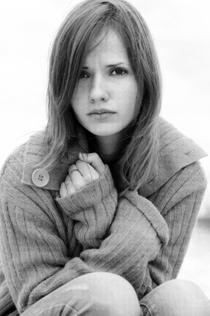 Fashionable, amazing, charming, dramatic, isolated, stressed, thoughtful, overworked, upset, worried portrait of beautiful girl looks attentively, thinks about problems, worries, fears.Black-and-white photo, nice, cold.Very upset, sad and depressed, but aの写真素材
