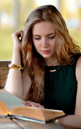 Calm, hard-working, serious, industrious and diligent student like reading book, read smart and new interesting boods.Very beautiful, cute, gorgeous, pretty, nice, attractive blonde girl with long, light hair read interesting book outdoors.Girl with book の写真素材