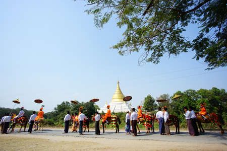Unidentified Myanmar people in traditional clothes walk on the road near Bagan, Myanmar.の写真素材