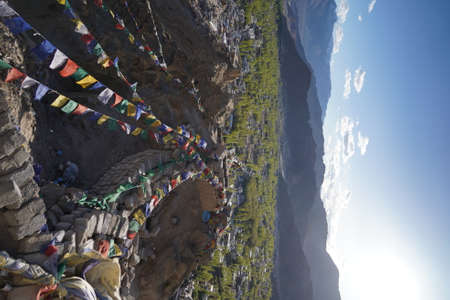 Tibetan prayer flags hanging from the top of a mountain