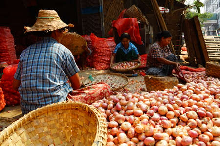 People activities in morning at traditional fresh market, street vendors and buyer of fresh fish, meat and vegetable. Local people in bustling morning market in Myanmar.のeditorial素材