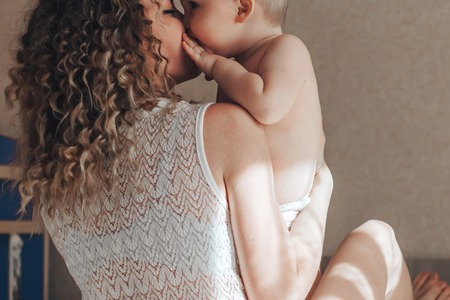 baby is kissing motherの写真素材