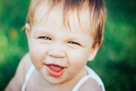 Image of sweet baby girl, closeup portrait of child, cute toddler with blue eyesの写真素材