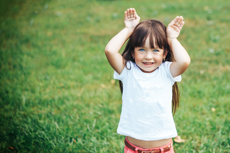 litlle girl showing ears of rabbit or hareの写真素材
